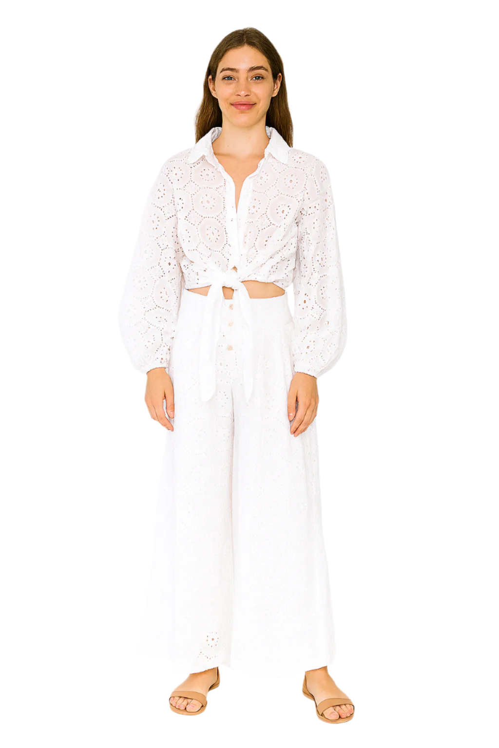 Woman wearing a white lace top and pants on a white background